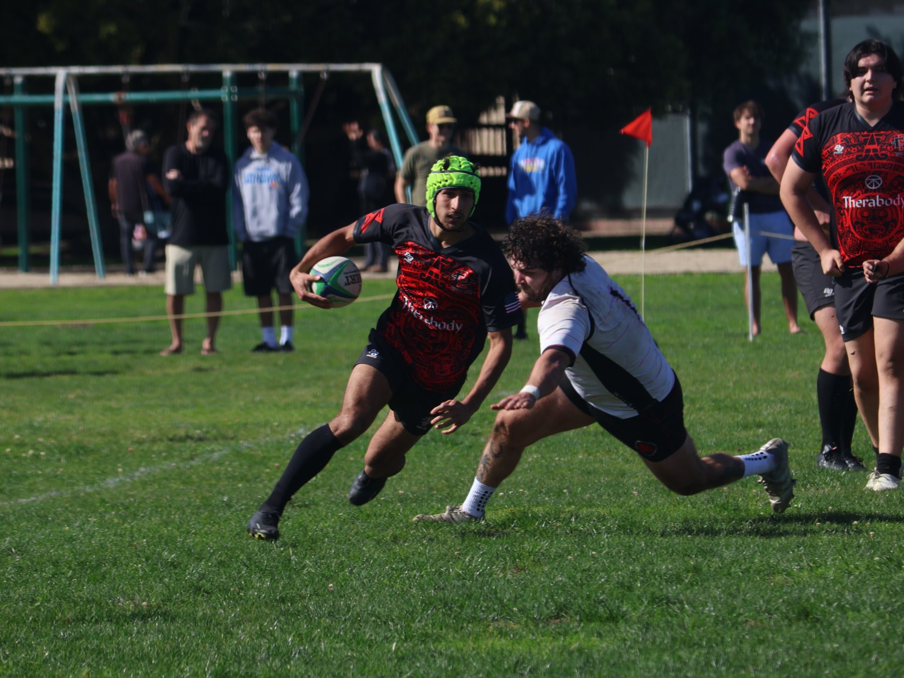 Rugby ball carrier evading a tackle during a match